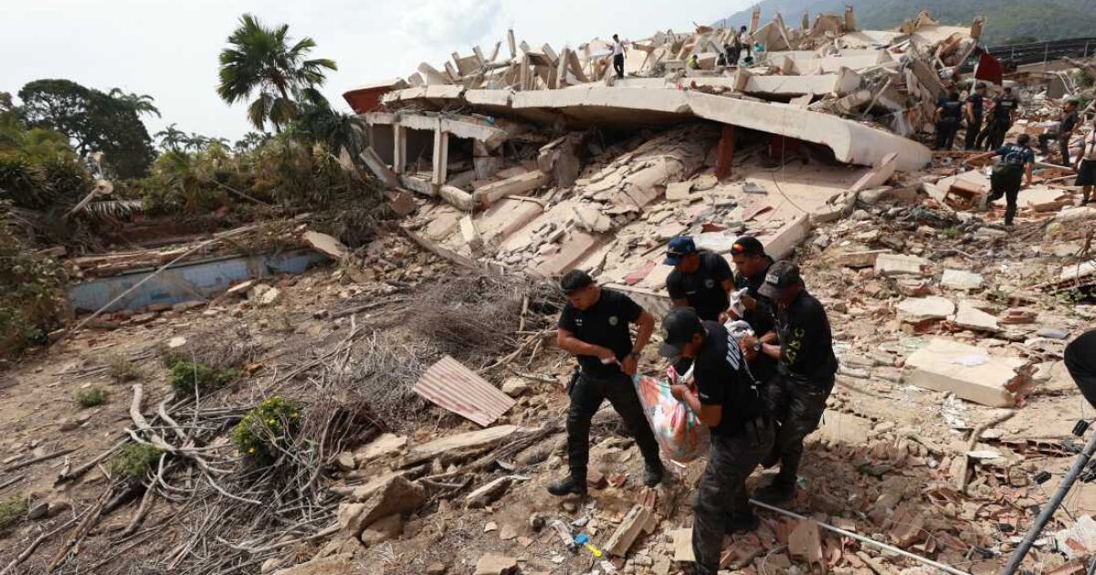 Police carry a body recovered from the rubble of a building in La Guaira, Venezuela, Thursday, June 25, 2026, a day after successive powerful earthquakes struck the country. (AP Photo/Javier Campos)